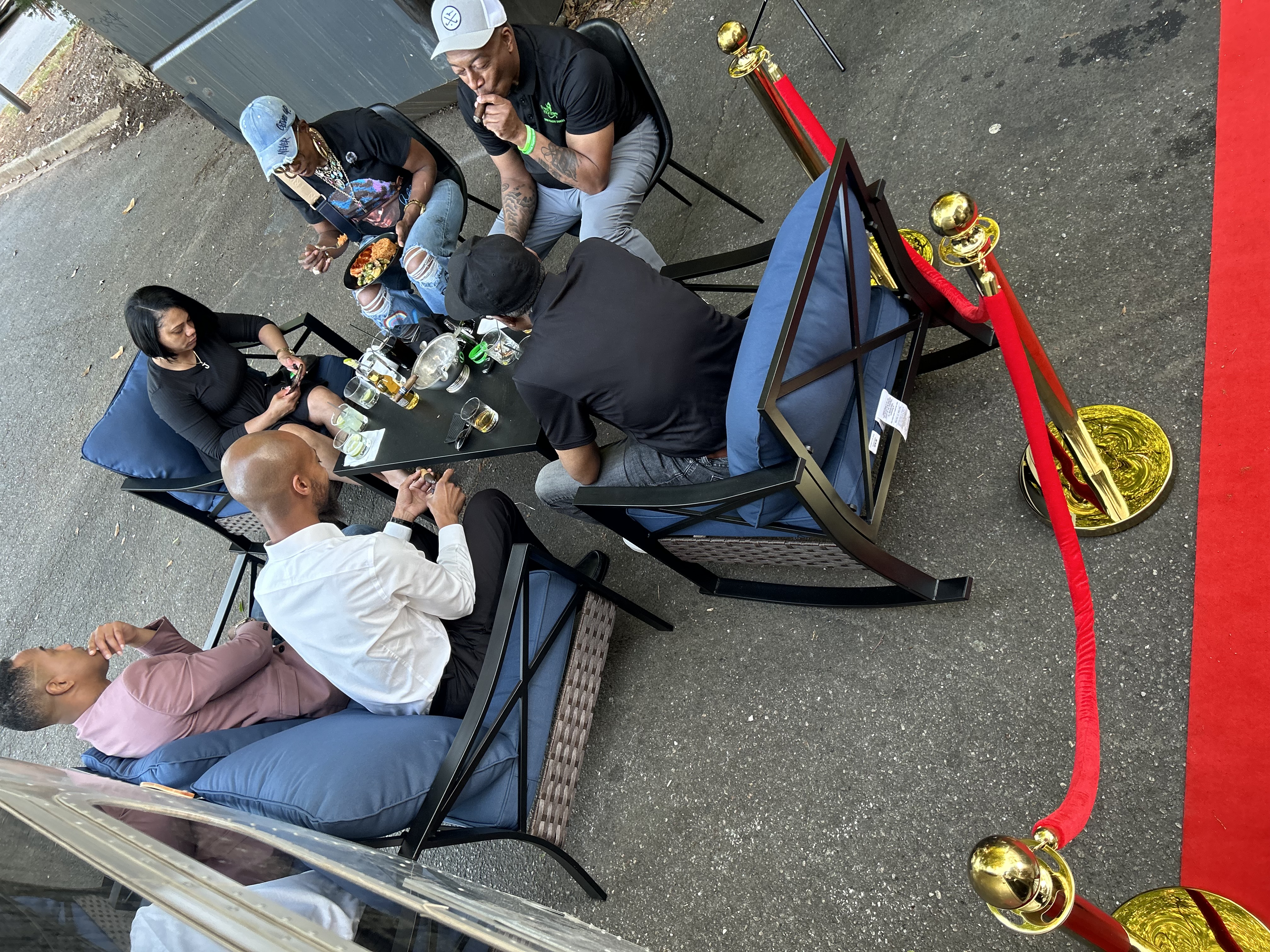 Guests seated in the outdoor lounge setup beside the Airstream at a private event